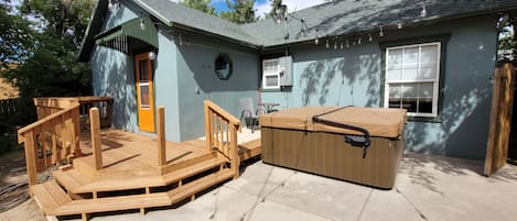 Rear deck with hot tub and string lights