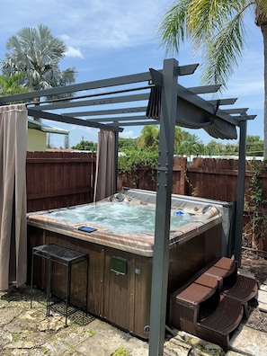 Out door hot tub, with retractable roof and privacy curtains.