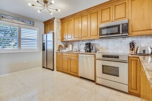 Spacious kitchen features modern appliances.