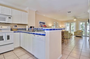 Bright kitchen features pops of color with blue tiles.