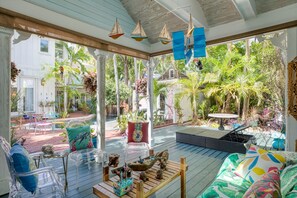 Covered outdoor lounge area with tons of comfortable seating.