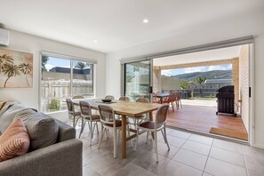 Main living and dining opens onto deck area. Sliding doors are flyscreened.