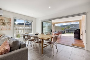 Main living and dining opens onto deck area. Sliding doors are flyscreened.