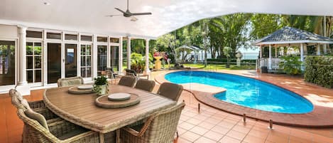 Huge outdoor entertaining area with BBQ overlooking the pool and beach