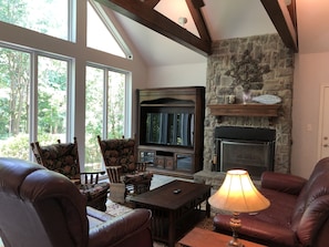 Living room with high vaulted ceiling.