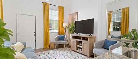 living room space equipped with comfortable seating and a tv 