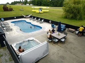 Spacious, private patio with 10-person hot tub, dining area, and pool