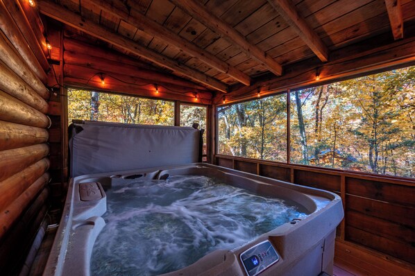 Relax in the hot tub anytime of year in the screened in porch 