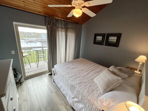 Master bedroom with queen bed and smart TV.