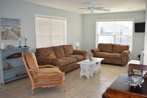 View of living room with ceiling fan