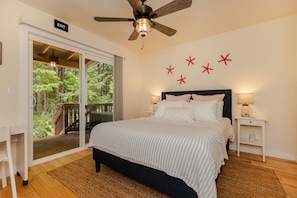 The main bedroom overlooks the wooded backyard with access to the rear deck. 