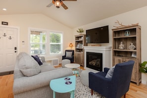 Cozy living area with gas fireplace and ample seating. Couch has pull out bed