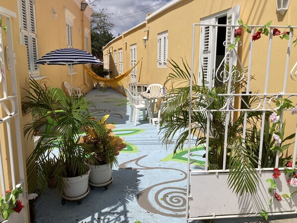 Entrance gate and apartment on the right.