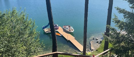 View of lake, dock, and slide from deck. Boats can be rented in Kalispell.