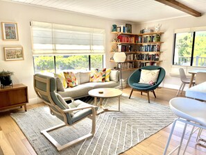 Sunny open-plan living room with bright, modern decor.