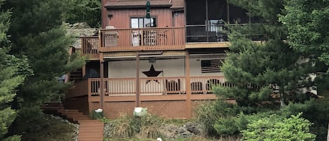 back of house view from the lake, private dock, 2 levels of deck, screened porch