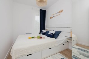 The cosy bedroom features a luxurious double bed and ample storage.