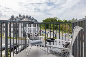 The balcony's stylish decor complements the apartment's modern design.