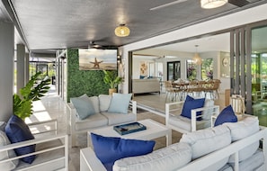 Slide open the glass wall and step into your breezy outdoor lounge — complete with hanging chairs perfect for morning coffee or evening cocktails