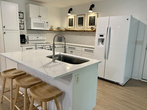 Kitchen stocked with coffee maker, blender, pots & pans, all major appliances