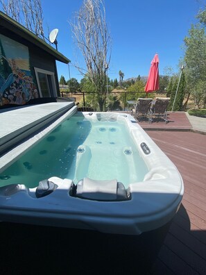 Large private spa right outside your bedroom slider & overlooking the lake.