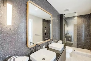 Double sink bathroom with modern shower