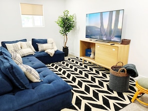 Ultra comfy TV room w/ large sectional sofa, 60" smart TV w/ Roku guest mode.