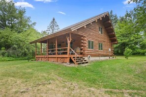 This rustic, cozy cottage is nestled around trees and offers breathtaking views of the surrounding landscape.