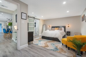 The primary bedroom provides the utmost in modern luxury with mid century modern furnishings