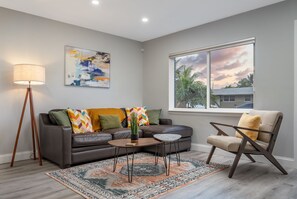 Comfortable living area with an abundance of natural light perfect for relaxing day or night