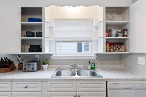 Well stocked kitchen with toaster, plates, bowls, seasonings and other essentials!