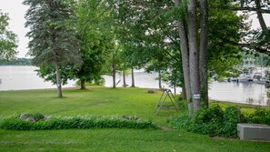 Slightly sloped front lawn leading to lake