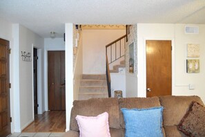 Stairs to upper level and 1/2 Bath
