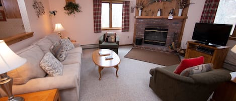 Sit back and relax in our cozy living area! (Please note that decor varies).