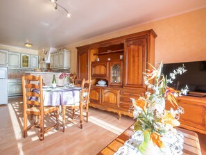 Furniture, Flower, Cabinetry, Picture Frame, Wood, Lighting, Orange, Interior Design, Plant, Living Room