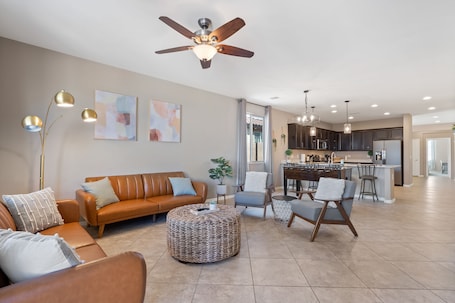 Comfy seating area, sofa and accent chairs in living room.