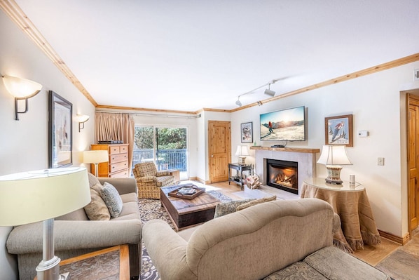 Relax in this oversized living room with ample seating and a private balcony.