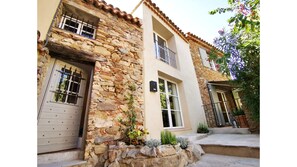 Exterior of house with enclosed outside terrace .