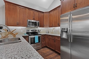 The kitchen features all stainless steal appliances