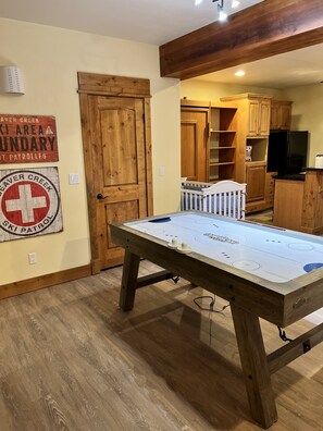 Game room in bunk room with football table, TV and exit to deck and hot tub! 