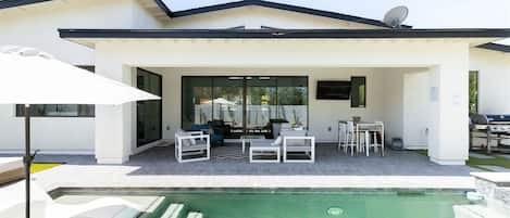 Pool with Tanning Ledge and Covered Patio