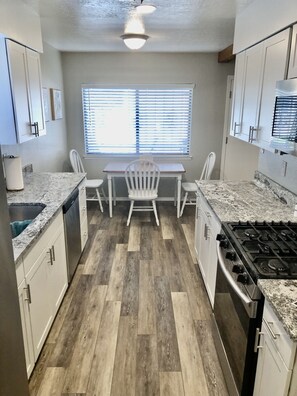 Kitchen with granite countertop’s & stainless steel appliances