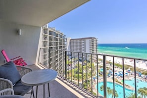 The condo offers a private balcony with views of the beach & pool.