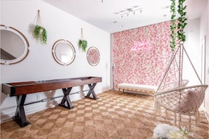 Insta-worthy game/lounge room w/ a full rose wall & neon sign on the 1st floors!
