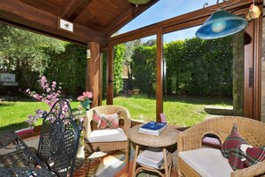 The equipped veranda with nice view on the well kept garden