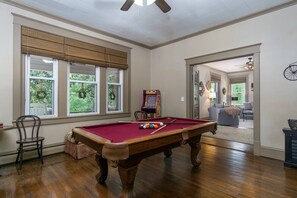 Recreational room has a pool table, stand-up arcade and various family-friendly games.