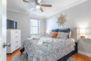 Queen bed with a ceiling fan