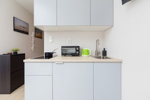 The fully equipped kitchenette includes everything you need for a home-cooked meal.