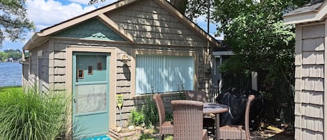 The cottage includes a grilling area with seating.