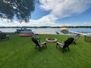 Private dock and lake access. grassy front yard with a fire pit
